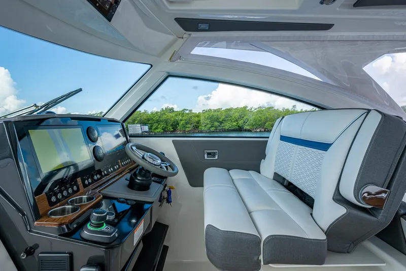 Slide: The Image of 2021 Tiara Yachts 38 LX helm with modern controls and luxurious seating. - 21