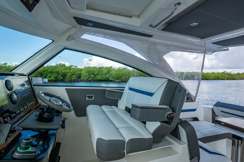 Slide: The Image of 2021 Tiara Yachts 38 LX helm with luxurious seating and advanced navigation system. - 22