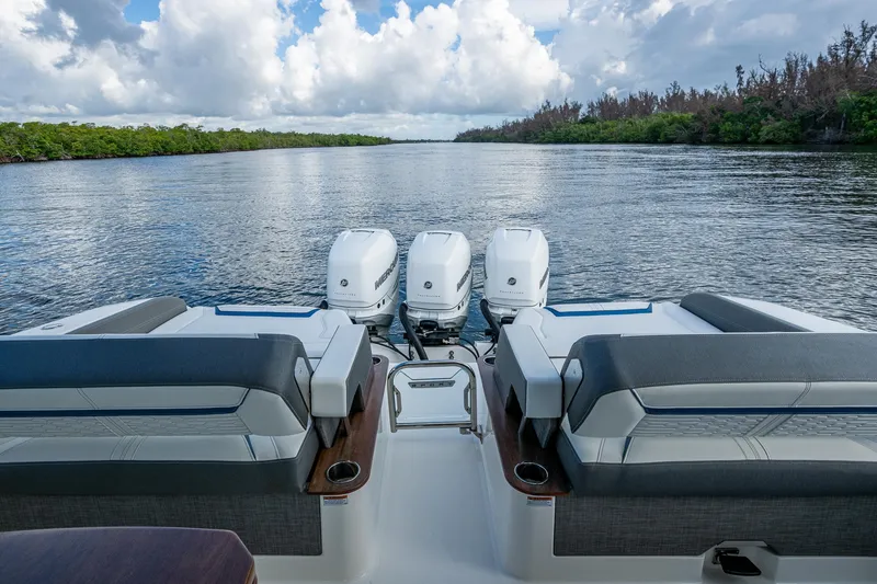 Slide: The Image of 2021 Tiara Yachts 38 LX with triple engines on a serene waterway. - 23