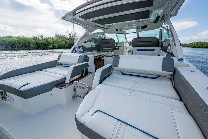Slide: The Image of 2021 Tiara Yachts 38 LX luxury boat interior with plush seating and scenic water view. - 24