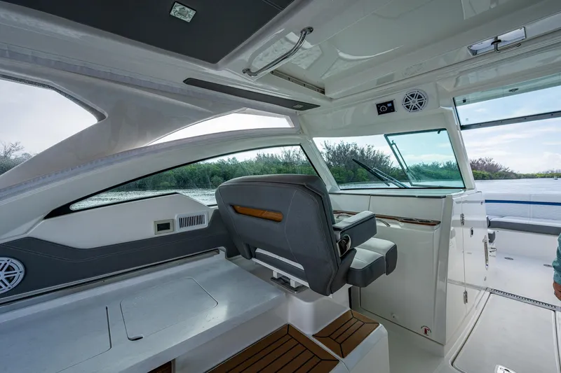Slide: The Image of 2021 Tiara Yachts 38 LX interior with helm seat and panoramic windows. - 27