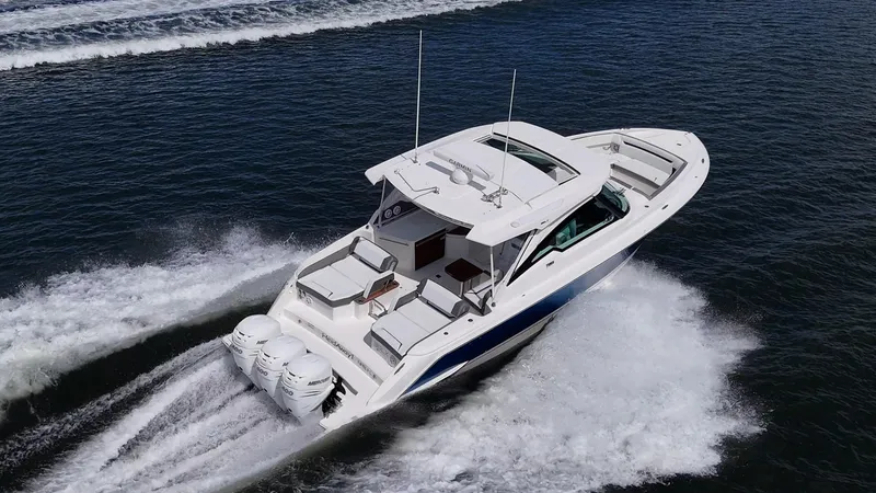 Slide: The Image of 2021 Tiara Yachts 38 LX cruising on open water, showcasing sleek design and powerful engines. - 3
