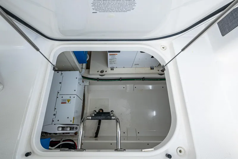 Slide: The Image of Engine compartment of 2021 Tiara Yachts 38 LX, showcasing mechanical components and storage space. - 30
