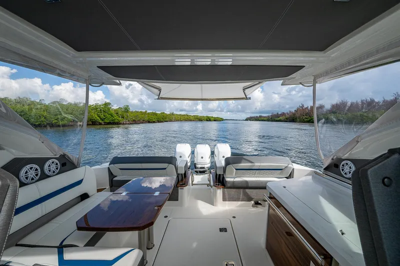 Slide: The Image of 2021 Tiara Yachts 38 LX interior with scenic waterway view, featuring luxurious seating and table. - 36