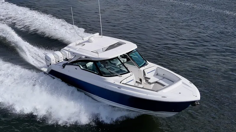 Slide: The Image of 2021 Tiara Yachts 38 LX cruising on open water, showcasing sleek design and powerful performance. - 4