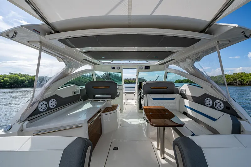 Slide: The Image of Luxurious 2021 Tiara Yachts 38 LX interior with seating, table, and scenic water view. - 40