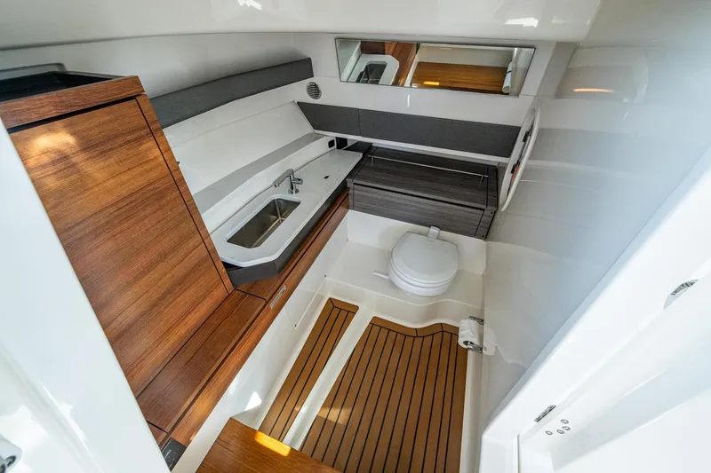 Slide: The Image of 2021 Tiara Yachts 38 LX interior with modern bathroom, wooden accents, and sleek design. - 42