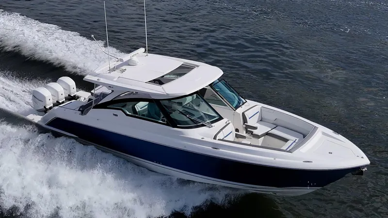 Slide: The Image of 2021 Tiara Yachts 38 LX cruising on water, showcasing sleek design and powerful engines. - 5