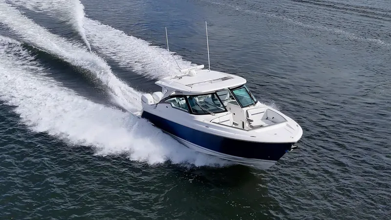 Slide: The Image of 2021 Tiara Yachts 38 LX cruising on open water, showcasing sleek design and performance. - 6