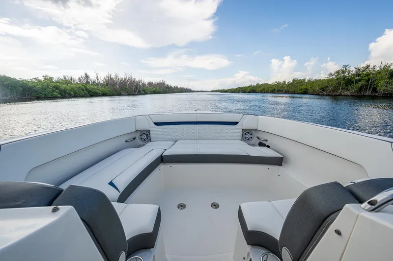 Slide: The Image of 2021 Tiara Yachts 38 LX boat interior with seating, on a scenic waterway. - 8