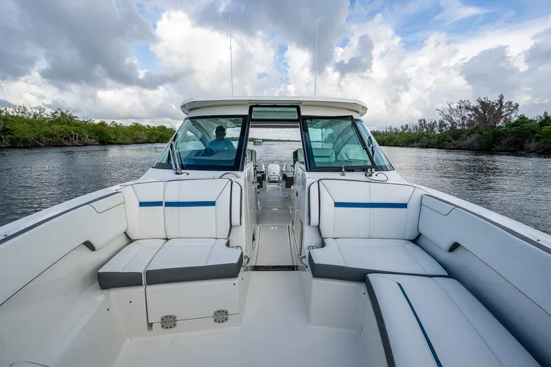 Slide: The Image of 2021 Tiara Yachts 38 LX with spacious seating, cruising on a scenic waterway. - 9