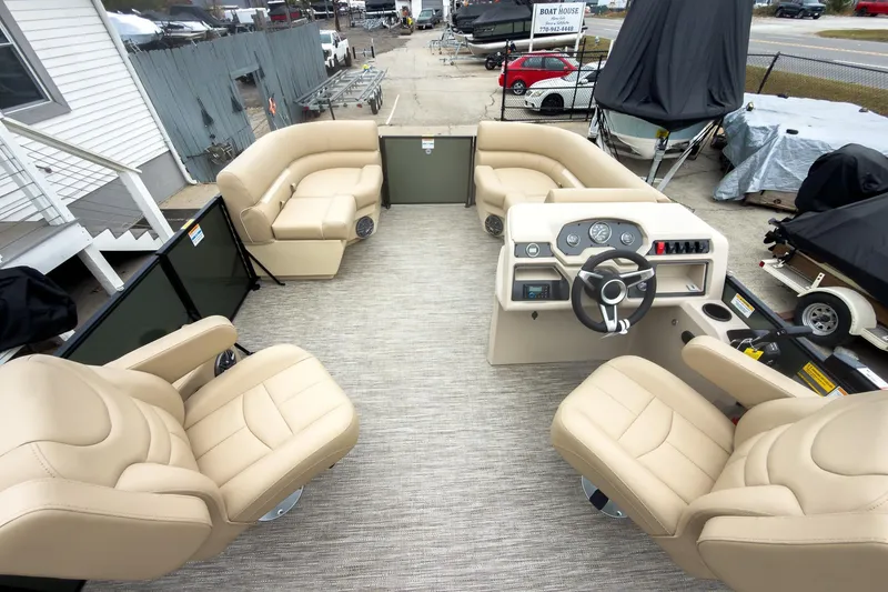 Slide: The Image of 2026 Godfrey Sweetwater Xperience 20' pontoon boat interior with beige seating and helm. - 22