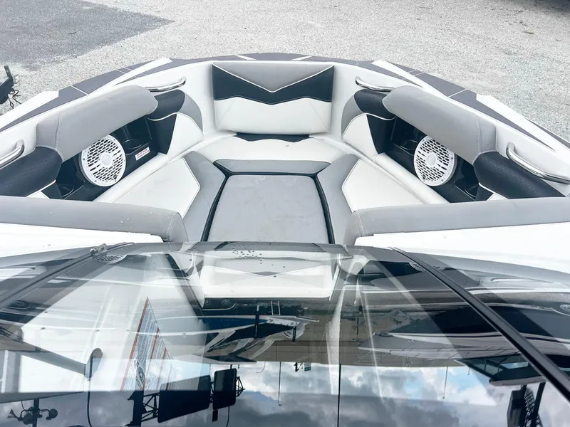 Slide: The Image of 2023 Supreme S220 boat interior with cushioned seating and built-in speakers. - 3