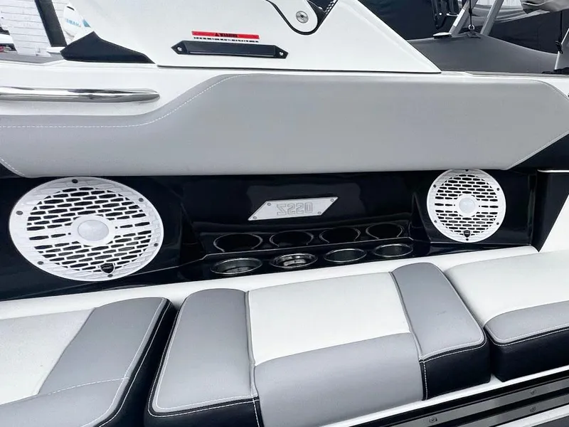 Slide: The Image of 2023 Supreme S220 boat interior with speakers and cushioned seating. - 6