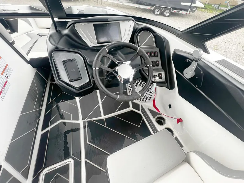 Slide: The Image of 2023 Supreme S220 boat interior with modern dashboard and steering wheel design. - 8
