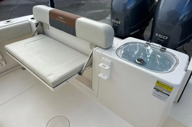 Slide: The Image of 2023 Cobia 240 Center Console boat with foldable seat and livewell. - 11