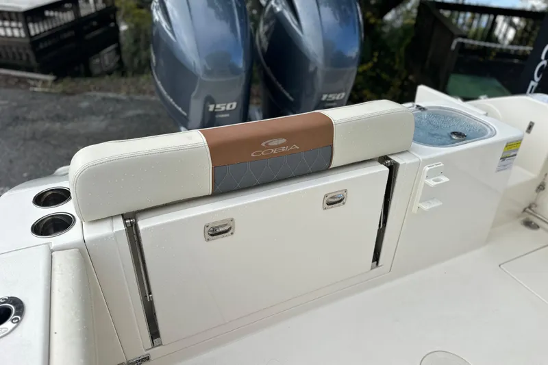 Slide: The Image of 2023 Cobia 240 Center Console boat with dual engines and seating area. - 12