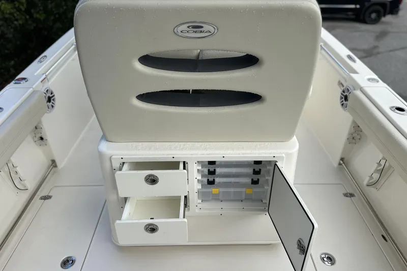 Slide: The Image of 2023 Cobia 240 Center Console boat with storage compartments and seating. - 14