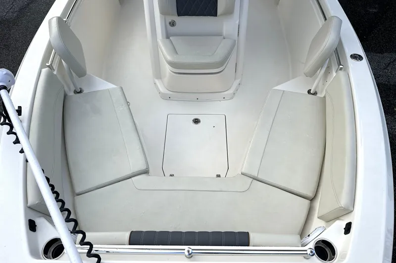 Slide: The Image of 2023 Cobia 240 Center Console boat interior with cushioned seating and storage. - 18