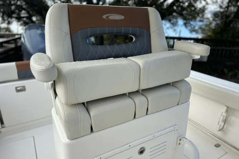 Slide: The Image of 2023 Cobia 240 Center Console boat seat with armrests, featuring a sleek design and comfortable padding. - 19