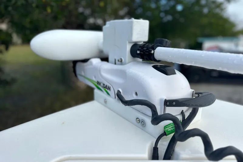 Slide: The Image of 2023 Cobia 240 Center Console boat with a white trolling motor detail. - 21