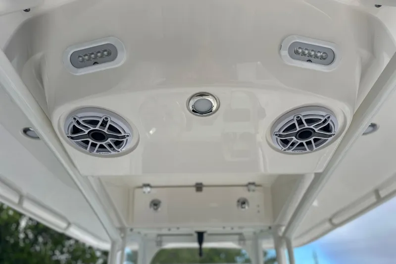 Slide: The Image of 2023 Cobia 240 Center Console boat speakers and lights on the ceiling. - 22