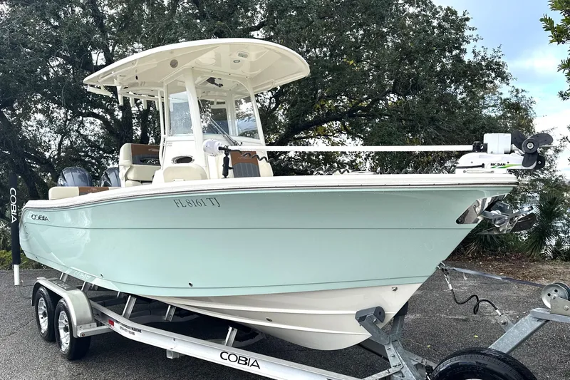 Slide: The Image of 2023 Cobia 240 Center Console boat on trailer, parked outdoors. - 6
