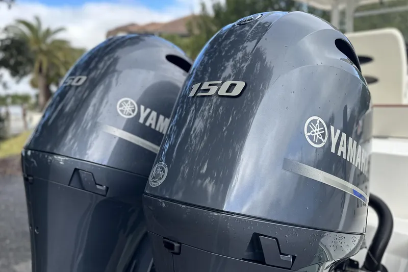 Slide: The Image of Twin Yamaha 150 outboard engines on a 2023 Cobia 240 Center Console boat. - 7