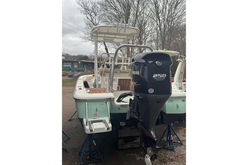 Slide: The Image of 2022 NauticStar 227 XTS boat with Yamaha 250 outboard motor, parked outdoors. - 5