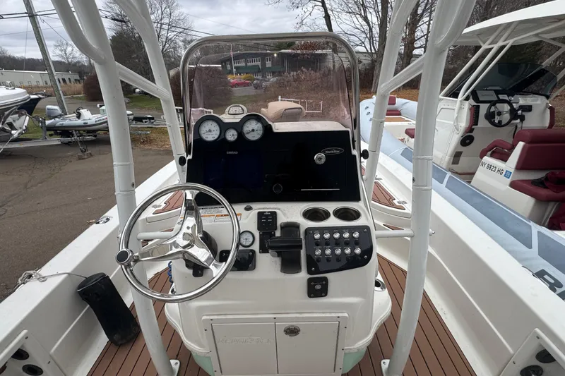 Slide: The Image of 2022 NauticStar 227 XTS boat console with steering wheel and gauges. - 7