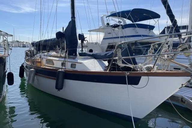 The Image of 1982 Formosa 42 sailboat docked in marina, featuring classic design and rigging. - 1
