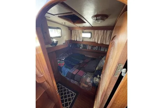 Slide: The Image of Cozy cabin interior of 1982 Formosa 42 sailboat with wooden furnishings and bed. - 11