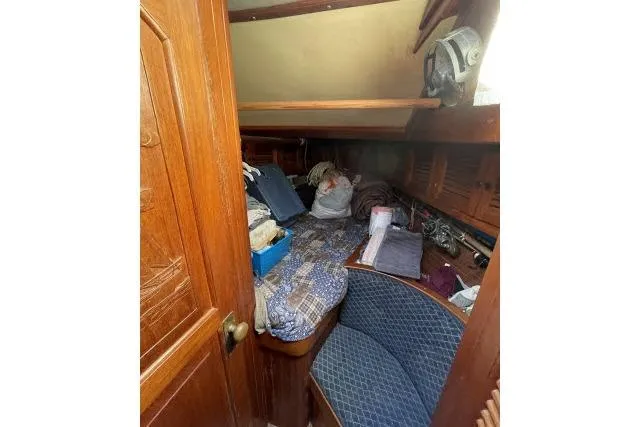 Slide: The Image of Cozy cabin interior of 1982 Formosa 42 sailboat with wooden furnishings and bedding. - 13