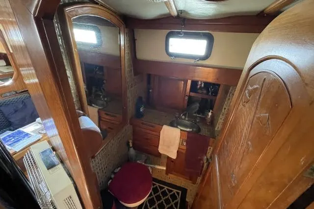 Slide: The Image of Interior of 1982 Formosa 42 sailboat bathroom with wooden cabinetry and mirror. - 14