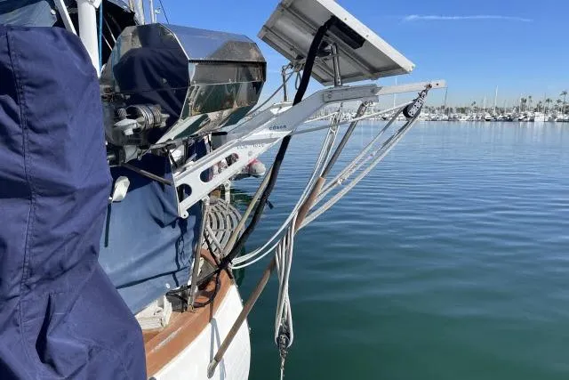 Slide: The Image of 1982 Formosa 42 sailboat with solar panels docked on calm water. - 19