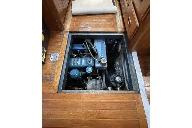 Slide: The Image of Engine compartment of a 1982 Formosa 42 sailboat, showcasing mechanical components. - 23