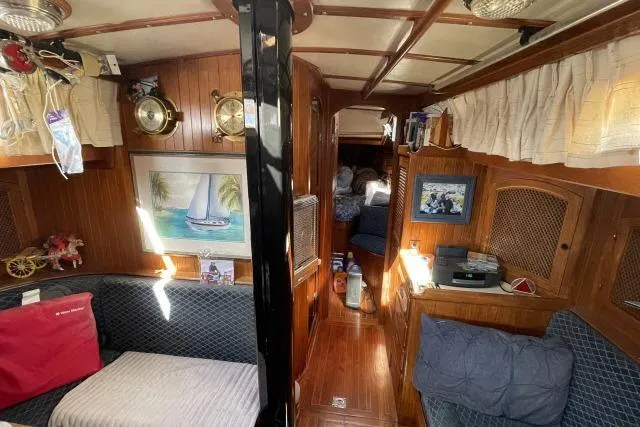 Slide: The Image of Interior of 1982 Formosa 42 sailboat with cozy wooden furnishings and nautical decor. - 3