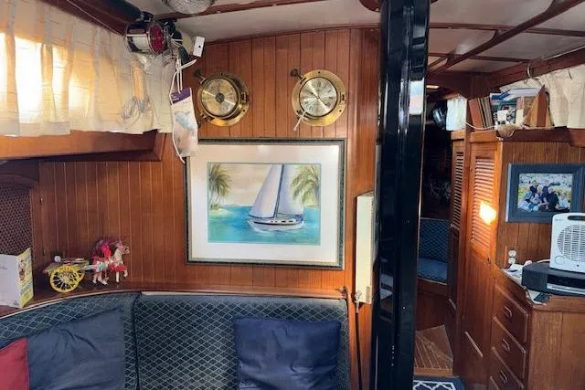 Slide: The Image of Interior of 1982 Formosa 42 sailboat with nautical decor and cozy seating area. - 4