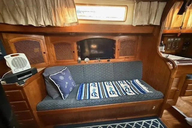 Slide: The Image of Cozy interior of 1982 Formosa 42 sailboat with cushioned seating and nautical decor. - 5