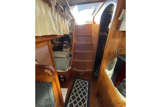 Slide: The Image of 1982 Formosa 42 yacht interior with wooden stairs and nautical decor. - 6