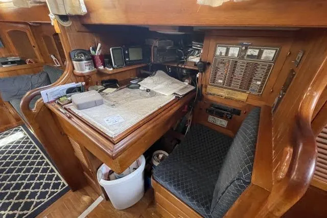 Slide: The Image of Navigation station inside 1982 Formosa 42 sailboat with chart table and instruments. - 9