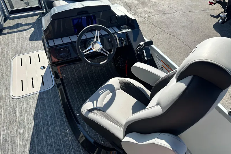 Slide: The Image of 2026 Premier 250 SunSation RF boat interior with steering wheel and captain's chair. - 10