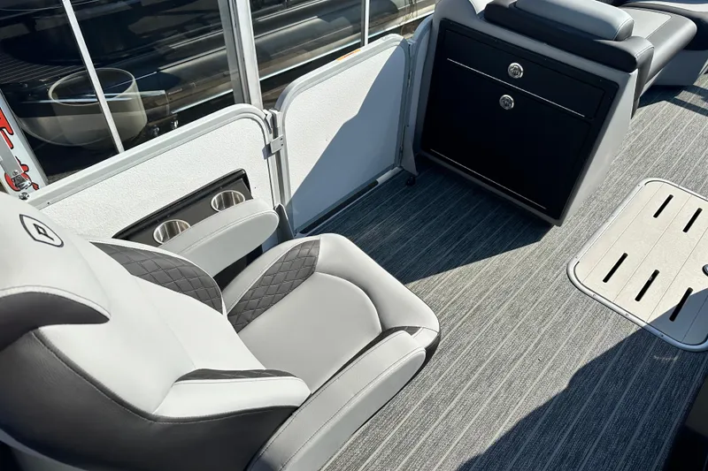 Slide: The Image of Luxurious interior of 2026 Premier 250 SunSation RF pontoon boat with plush seating and storage. - 12