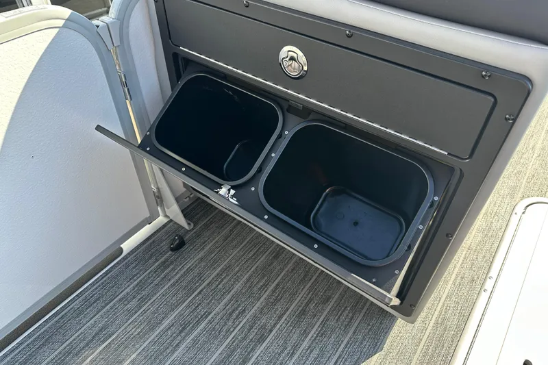 Slide: The Image of Storage compartment with bins on a 2026 Premier 250 SunSation RF boat. - 13