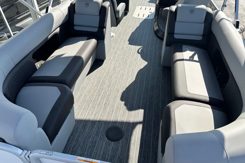 Slide: The Image of Interior of 2026 Premier 250 SunSation RF pontoon boat with gray seating and flooring. - 15