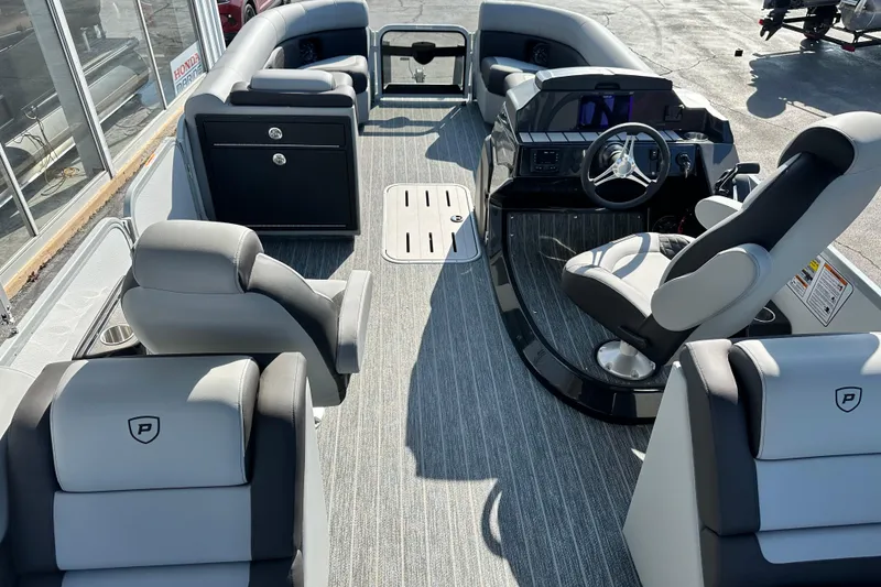 Slide: The Image of Interior of 2026 Premier 250 SunSation RF pontoon boat with modern seating and steering console. - 16