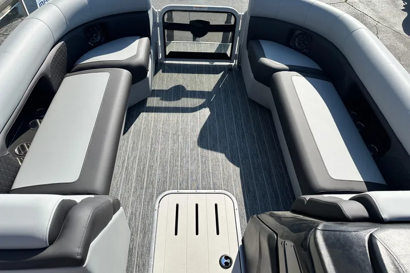 Slide: The Image of Interior of 2026 Premier 250 SunSation RF pontoon boat with gray seating and flooring. - 17