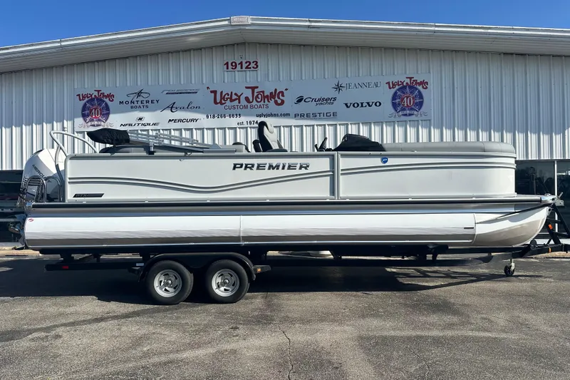 The Image of 2026 Premier 250 SunSation RF pontoon boat on trailer outside dealership. - 3