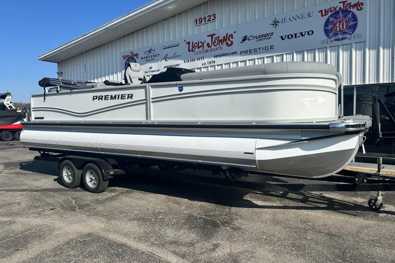 Slide: The Image of 2026 Premier 250 SunSation RF pontoon boat on trailer outside dealership. - 5
