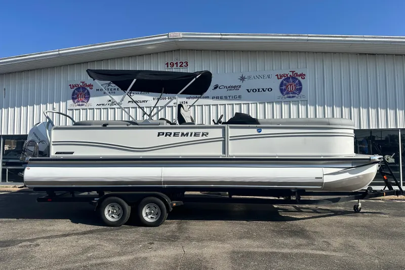Slide: The Image of 2026 Premier 250 SunSation RF pontoon boat on trailer outside dealership. - 6